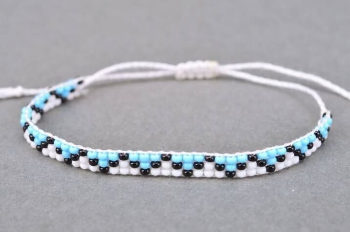 Bracelet made of threads and beads is a talisman that brings good luck to the owner